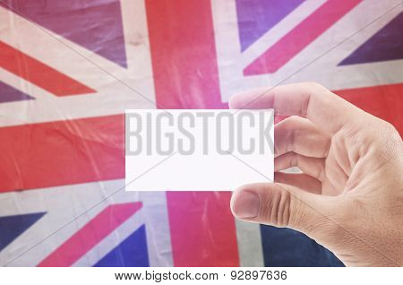 Man Holding Blank Business Card Against United Kingdom Flag