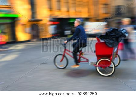 Trishaw Rides Quickly Along The Street Of The Old Town. Blurry