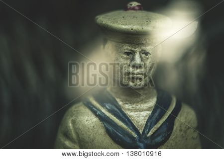 Portrait of a sailor figurine photographed in Odessa through the glass funiture in the store, the old Russian manipulative optics.