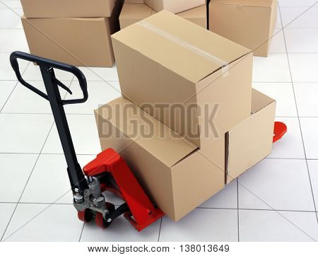 Manual pallet truck with carton boxes indoors