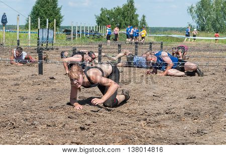 Tyumen, Russia - July 9, 2016: Steel Character extrim race on Voronino Hill. Army Test. People jumping, crawling, passing under a barbed wires or climbing obstacles during extreme obstacle race