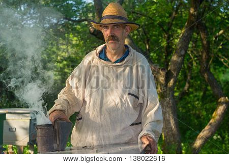 Portrait of Ukrainian bee-keeper at work place