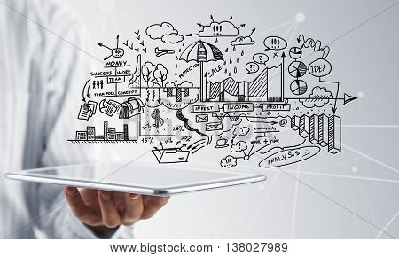 Businessman hand demostrating business strategy plan on tablet screen