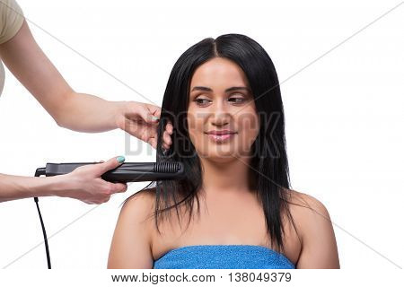 Young woman getting hair straightner isolated on white