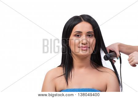 Young woman getting hair straightner isolated on white