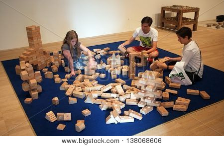 LONDON,UK - JULY 06, 2016: Visitors use wooden bricks to create interactive art piece in New Tate Modern Building, London