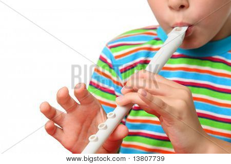 Body of small boy in striped shirt with zeal blowed white horn, focus on hands
