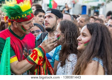 PORTO, PORTUGAL - JUL 10, 2016: Portuguese fans during translation of the football match Portugal - France final of the European championship 2016, in Liberdade Square at city center of Porto. 