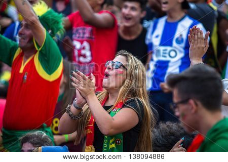 PORTO, PORTUGAL - JUL 10, 2016: Portuguese fans during translation of the football match Portugal - France final of the European championship 2016, in Liberdade Square at city center of Porto. 
