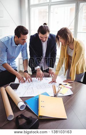 Archtects looking at construction plan in the office