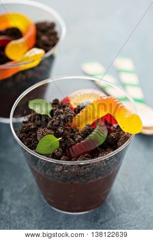 Children chocolate pudding dessert in a cup called dirt and worms