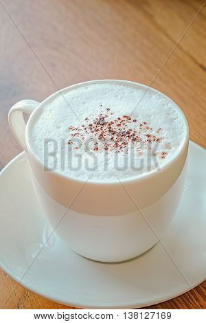 Cappuccino with cinnamon on a decorative background