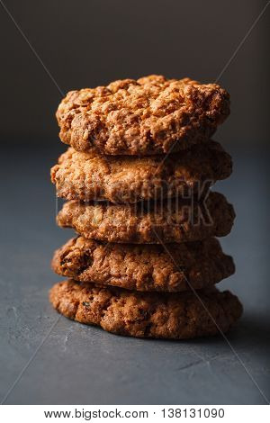 Close-up photo of oatmeal cokies stack on gray textural background
