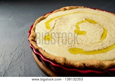 Close-up photo of tart with cream and olive oil, prepared for baking, selective focus