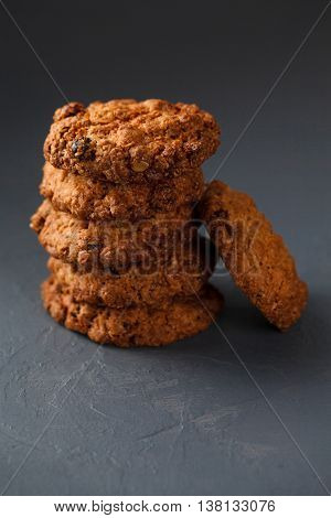Close-up photo of oatmeal cokies stack on gray textural background