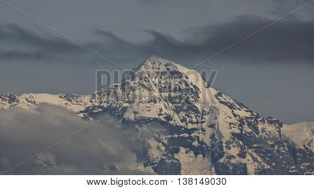 Peak of Mt Monch and clouds. Scene in the Swiss Alps.