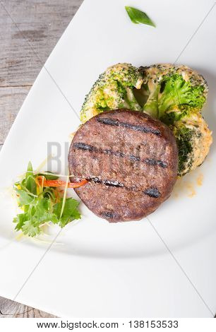 Fried beef cutlet served with broccoli garnish