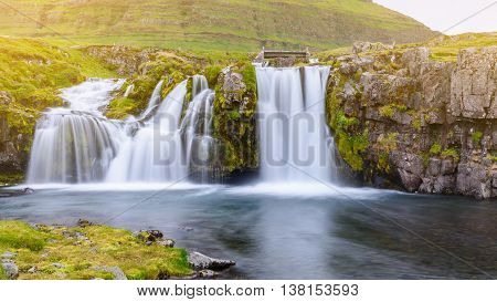 Beautiful waterfall landscape at Kirkjufell mountain Snaefellsnes peninsula Iceland with soft light effect