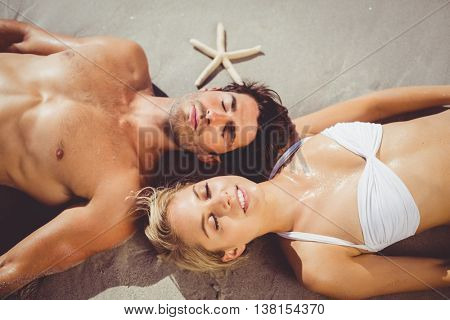Young couple lying on beach