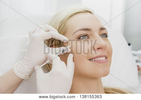Beautiful woman gets beauty facial injections. Face aging injection. Aesthetic Cosmetology