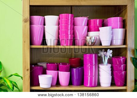 new violet flowerpots in a shelf in a market