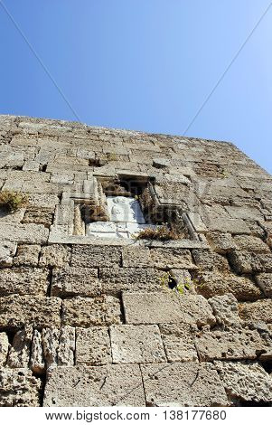 decorative panel on the ancient wall of sandstone