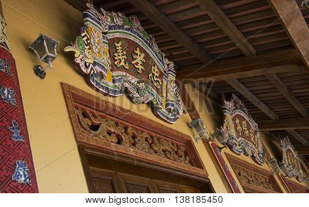 Hue, Vietnam - Jun 16, 2016: Close up of wooden details and decorations on the wall of Forbidden City of the Imperial Royal Palace of Nguyen dynasty.