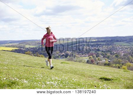 Mature Woman Jogging In Countryside