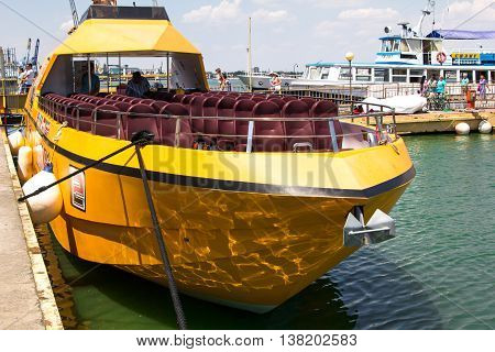 Odesa, Ukraine - July 03, 2016: Yacht club with parked ships of different models. Yellow pleasure boat for tourists. Port of Odesa