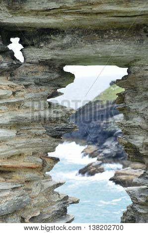 View of coastline through ancient stone portal