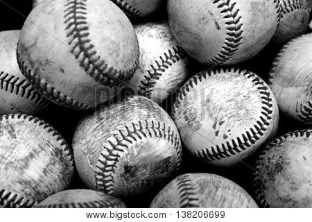 Pile and stack of old worn baseballs for sports and recreation pasttime