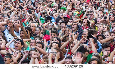 PORTO, PORTUGAL - JUL 10, 2016: Portuguese fans during translation of the football match Portugal - France final of the European championship 2016, in Liberdade Square at city center of Porto. 