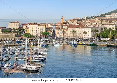 Ajaccio France - May 27 2016: View of the center of capital city of Corsica and birthplace of Napoleon Bonaparte with its marina Fishing Port water front and a part of the citadel on the left.