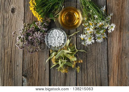Ancient herbal medicine on rustic wooden background