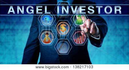 Male entrepreneur is pushing ANGEL INVESTOR on an interactive touch screen. Start up finance concept for business angel informal investor angel funder or seed investor especially the tech sector.