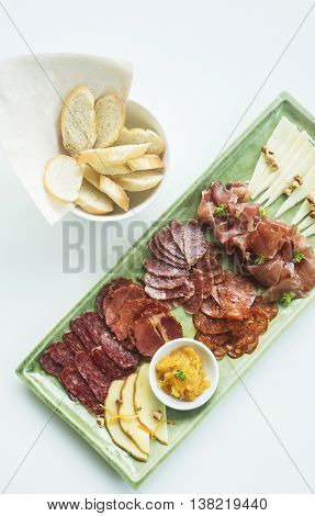 spanish serrano ham chorizo sausage and cheese tapas snack platter