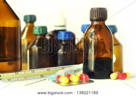 Medical bottles for mixtures, syrups and healthcare oils on white background