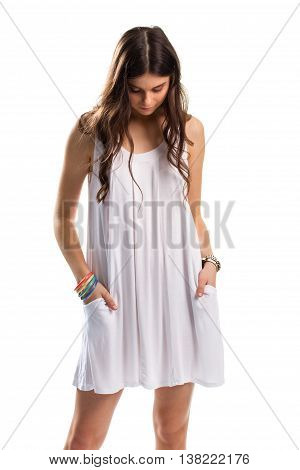 Woman in sarafan looks down. Set of colorful bracelets. Sad model on white background. Moment of sorrow.
