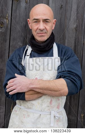 Portrait Of Man In Thick Clothing And White Apron