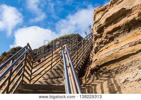 Beach access staircase, view looking up with cliff, Ladera Street, Sunset Cliffs, San Diego, California.
