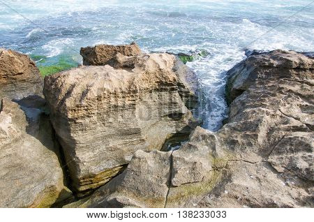 Closeup of the natural coastal limestone formation with the Indian Ocean waters on the coast line at Penguin Island in Rockingham, Western Australia.