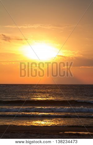 the setting sun over lake michigan beach