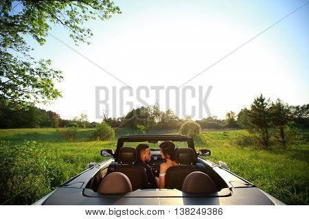 bride and groom. Young wedding couple enjoying romantic moments outside on a summer meadow. Happy bride and groom on their wedding. Stylish beautiful happy bride and groom wedding celebrations