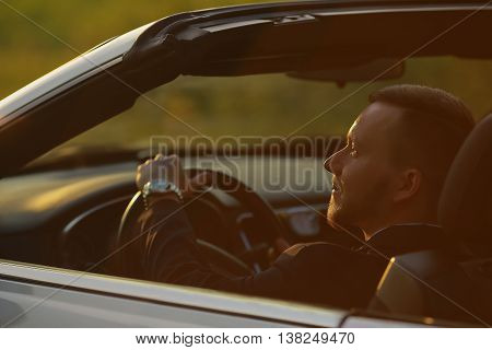 Portrait of a businessman, Businessman by car, portrait of a man, driving a convertible