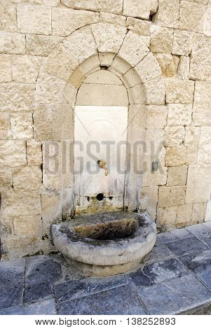 ancient weathered current drinking source in the fortress of Rhodes