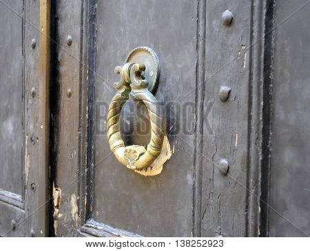 old brass door handle on the gate to the yard