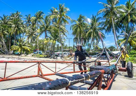 Labuan,Malaysia-Aug 29,2015:Labuan traditional fisherman returning from the sea after fishing activity at Labuan tropical island.Fishing is one of the main occupations of local people in Labuan island.
