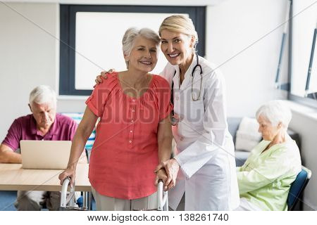 Nurse helping senior with walking aid in a retirement home