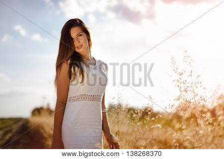 Dreamy beautiful sexy woman posing in fields