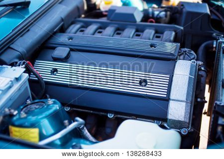 Close-up photo of old motor with intake manifold.